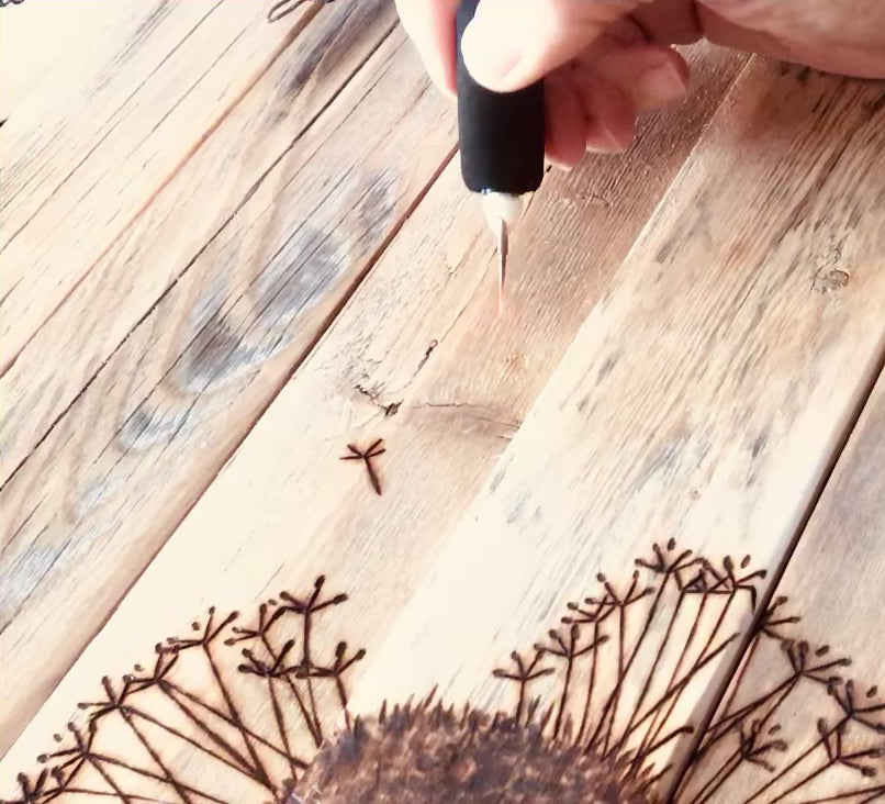 Woodburning a dandelion flower