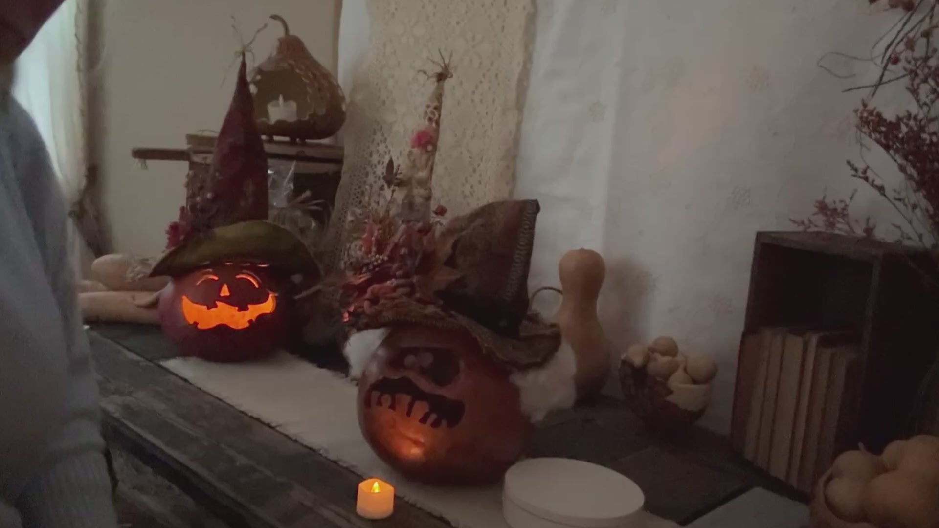 lighting a handmade ghostly pumpkin gourd