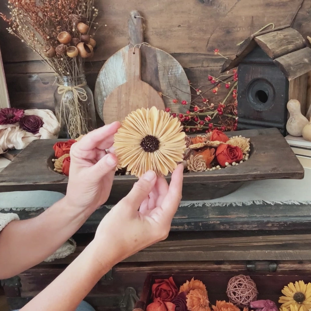 DIY dough bowl botanical arrangement with wood Gerba daisy.
