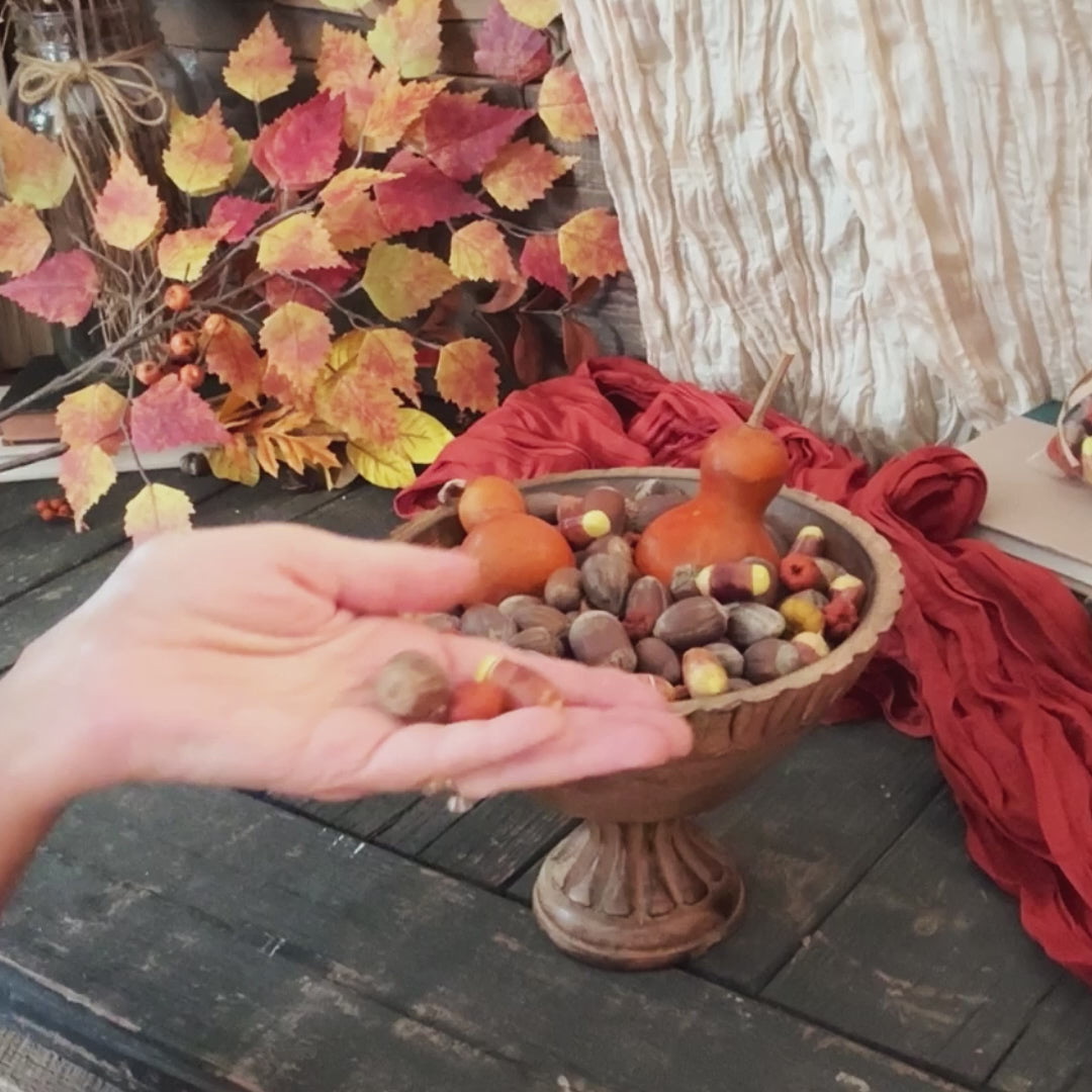 a video showing a wooden bowl filler arrangement for autumn table decorating