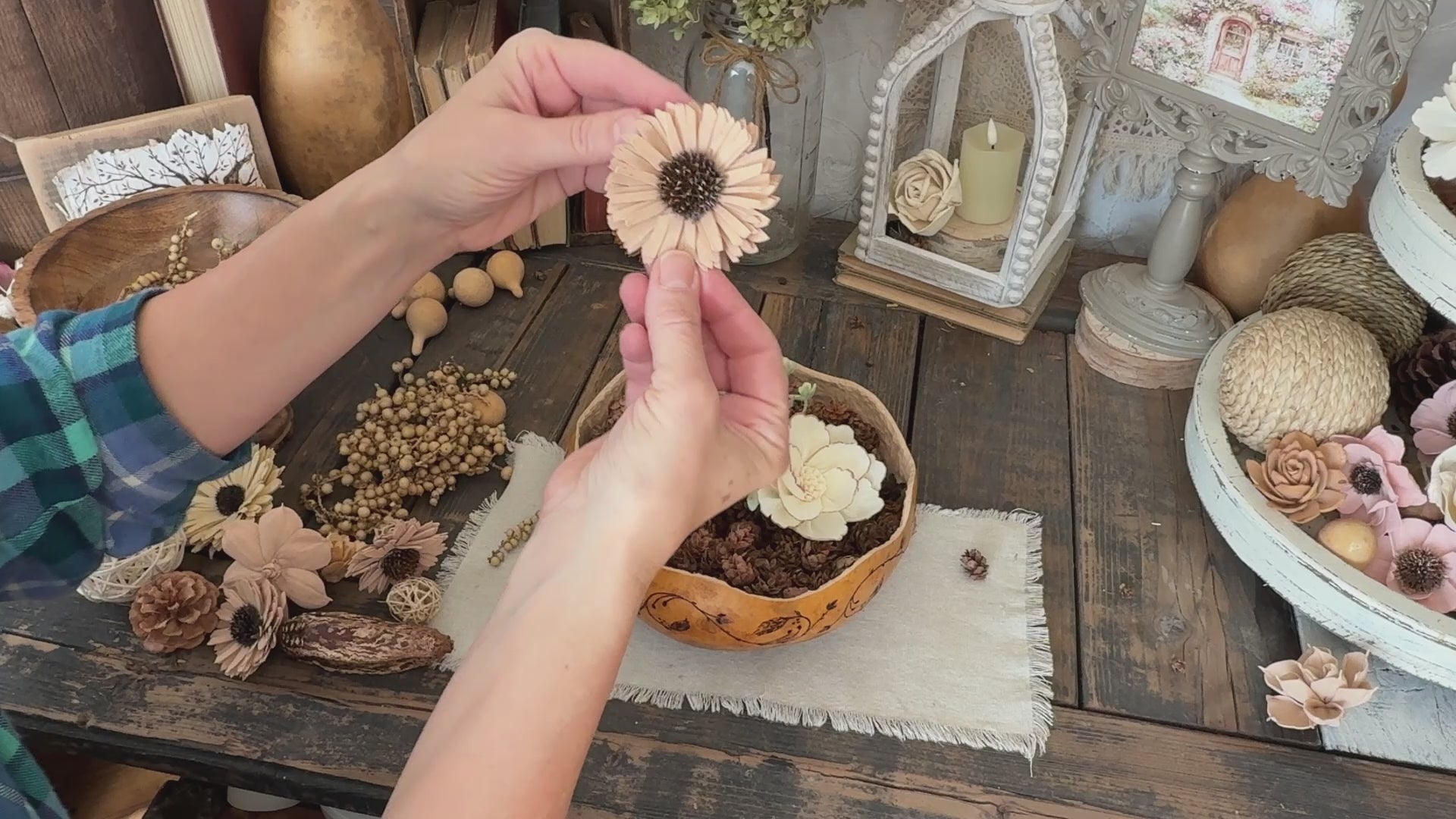 Video showing a decorative gourd bowl arrangement being assembled
